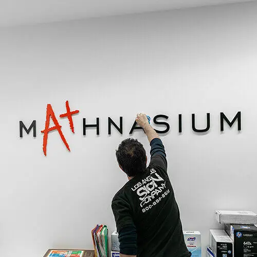 Ma+hnasium wall sign install